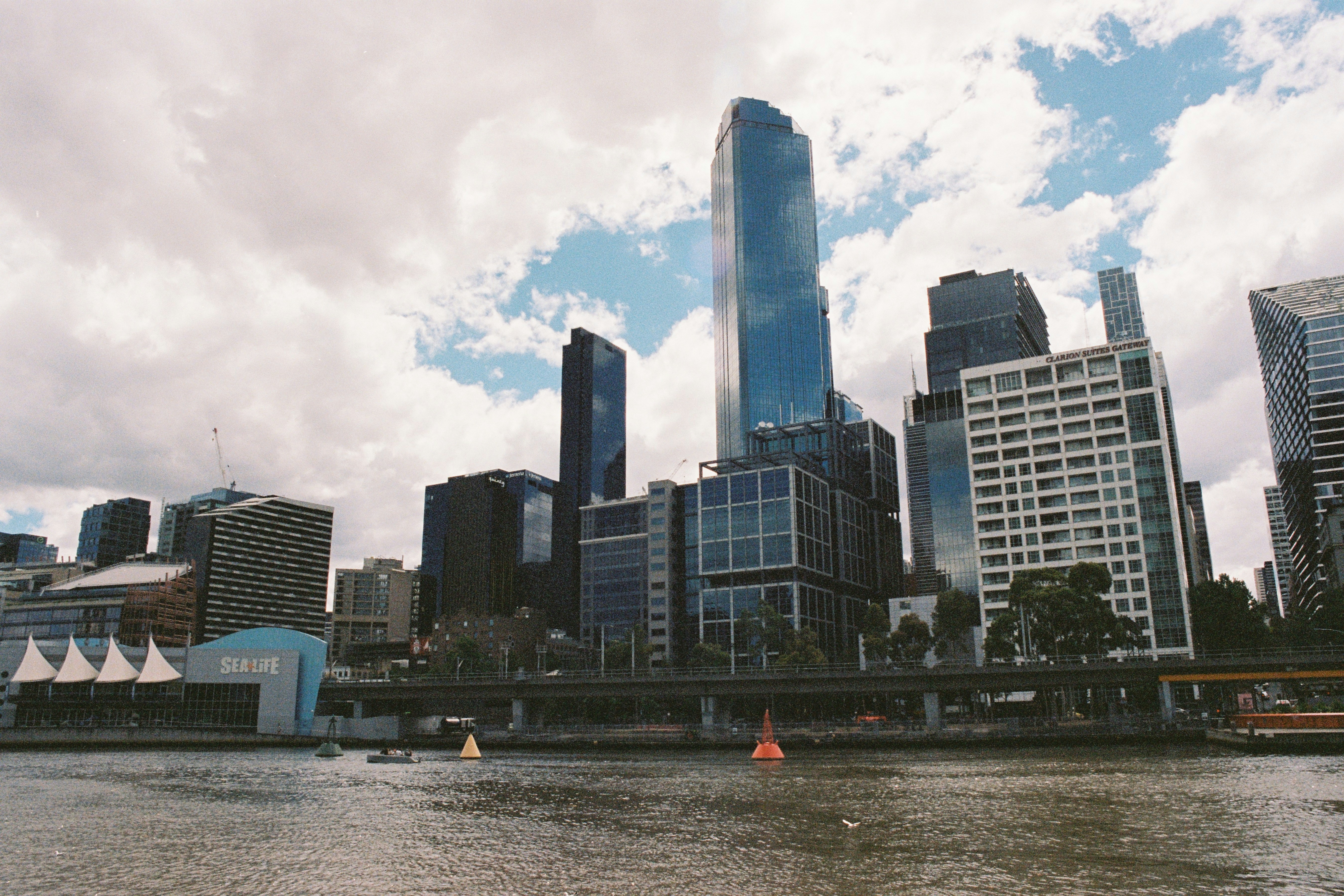 white and blue high rise buildings near body of water during daytime