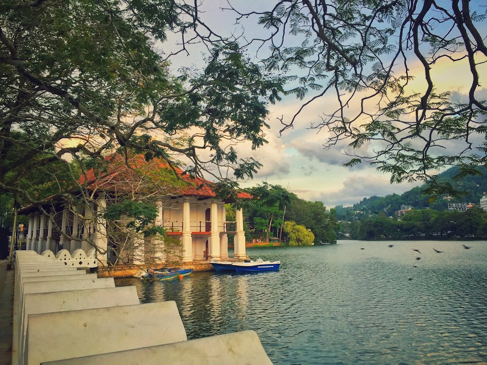 white and brown concrete building near body of water during daytime