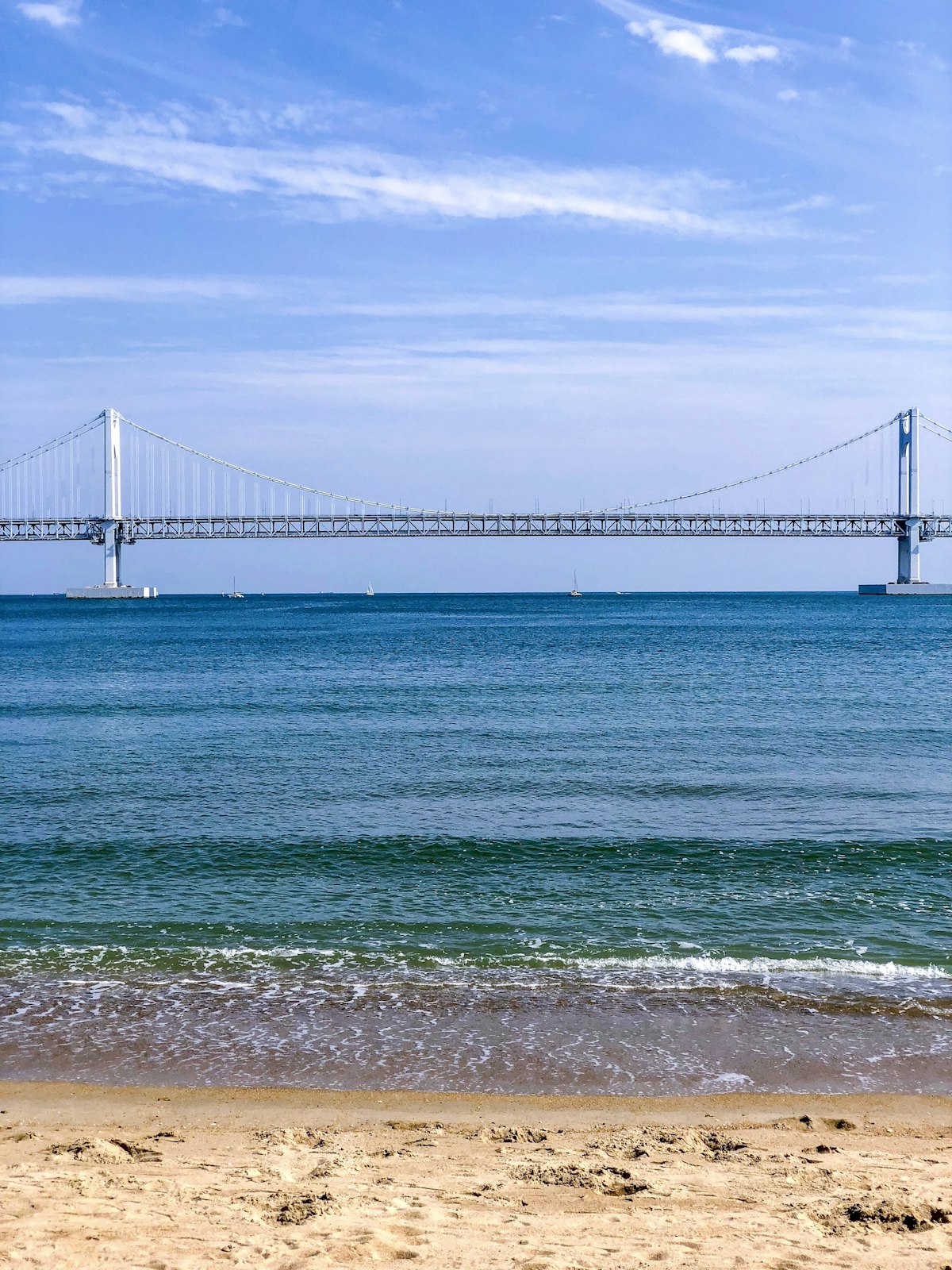 Busan November — Gwangalli Beach with the illuminated Gwangan Bridge in calm autumn evening