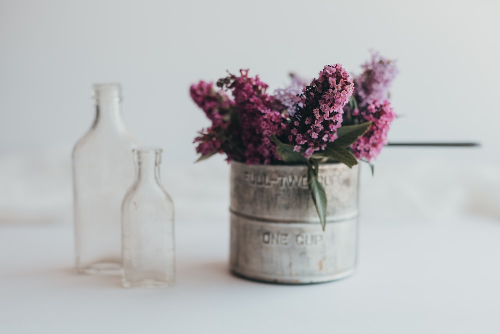 pink flowers in glass bottle