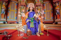 Close-up of the deity Vishnumaya in the Kubera posture with two hands.