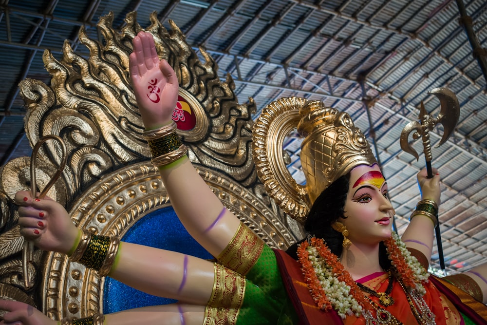 woman in gold and red sari dress