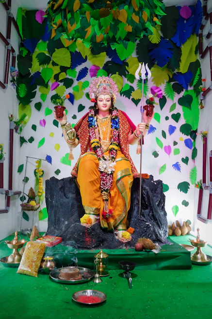 A vibrant statue of Iemanjá by the sea, with offerings of shells and water reflecting the sunset.