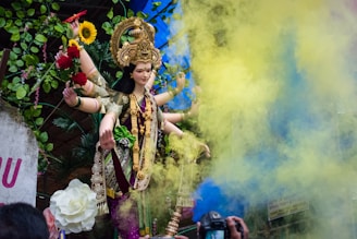 woman in gold and white floral dress wearing gold crown