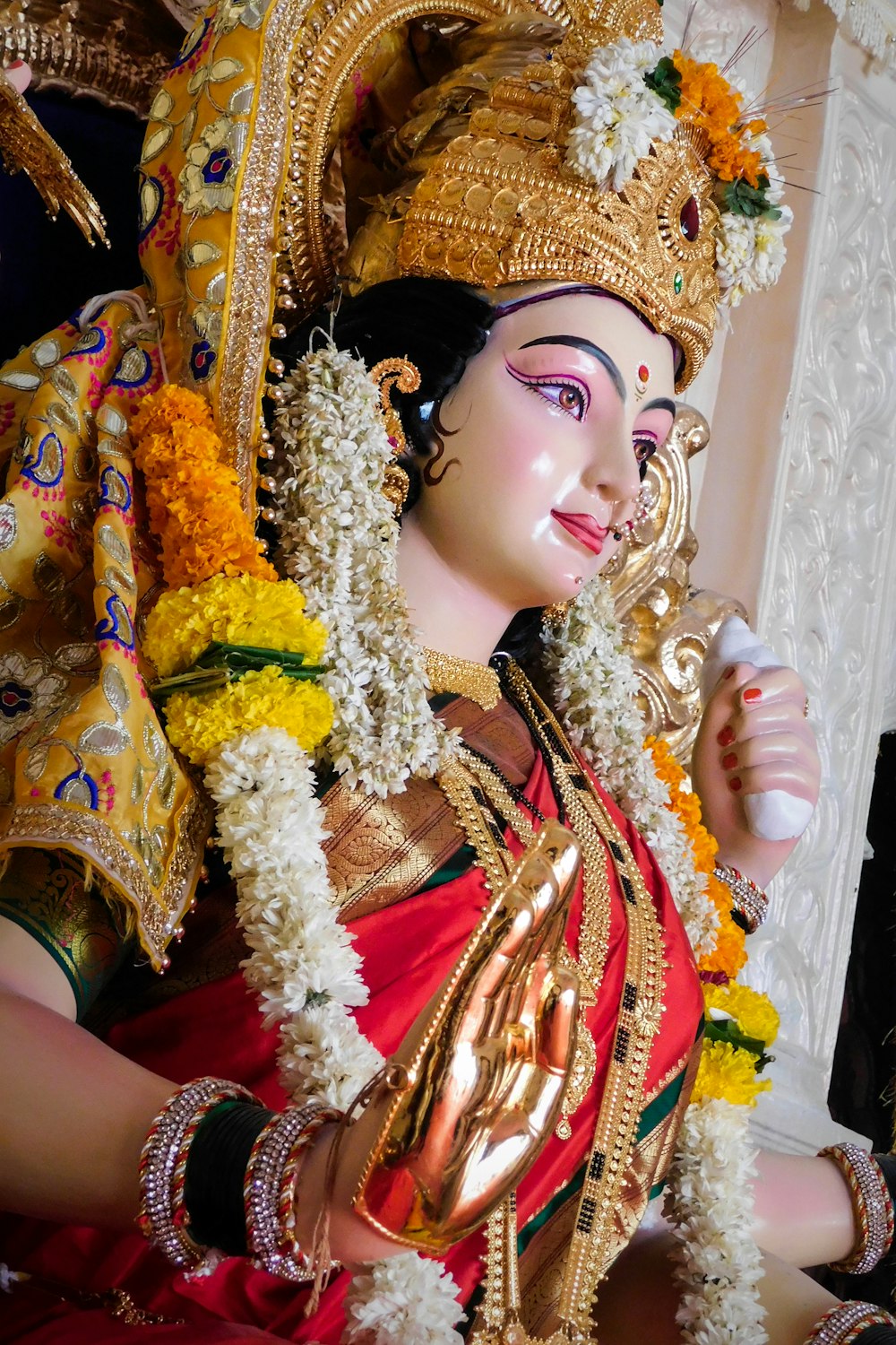 mulher no vestido de sari dourado e vermelho