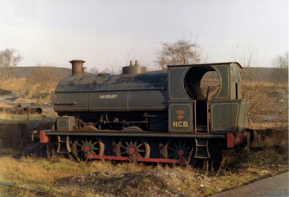 black and red train on rail tracks during daytime