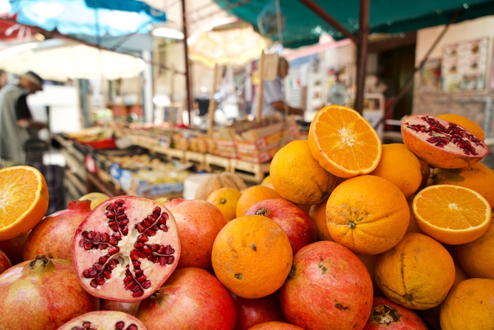 orange fruits on display during daytime