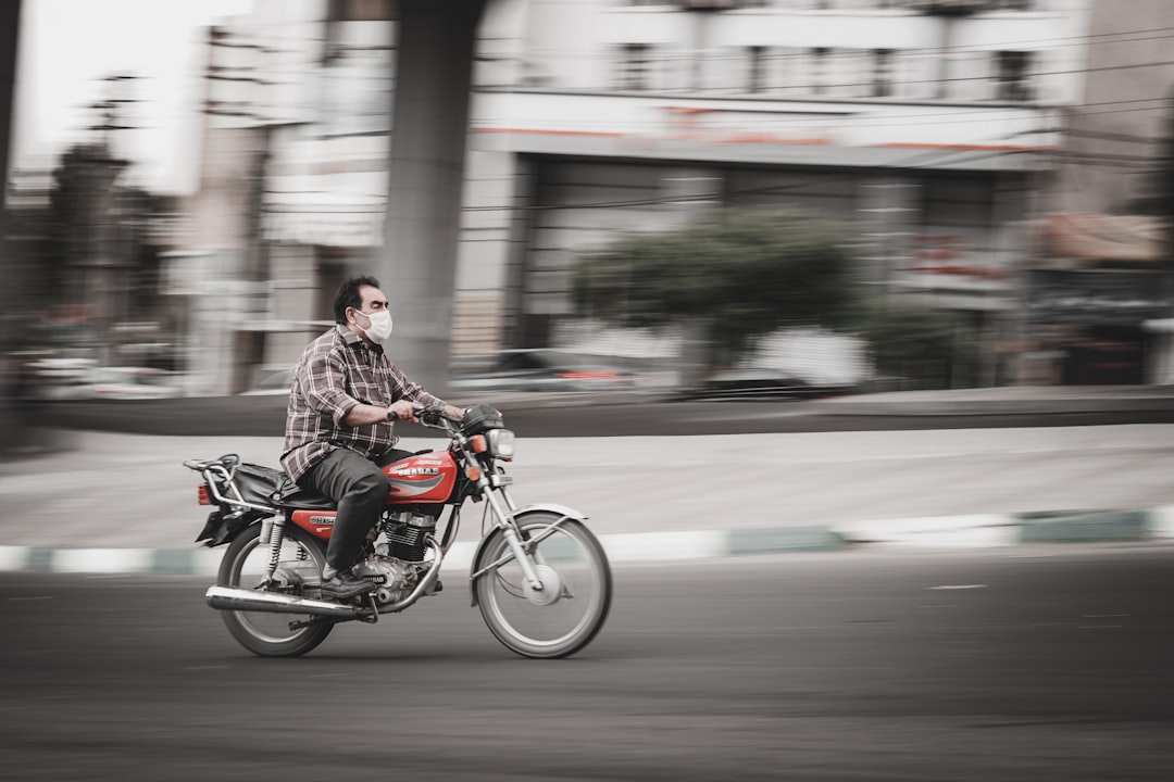man in brown jacket riding motorcycle