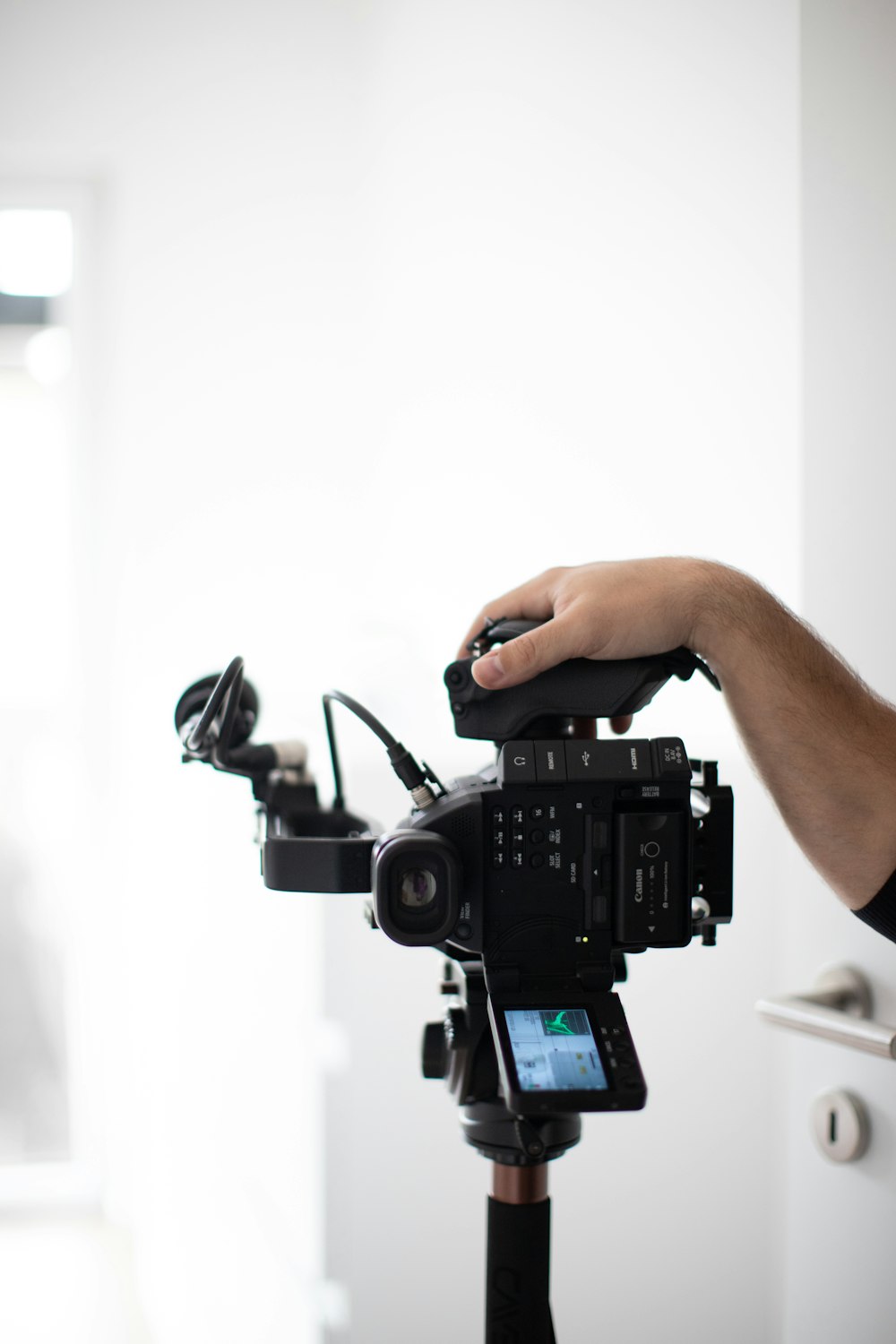 person holding black dslr camera