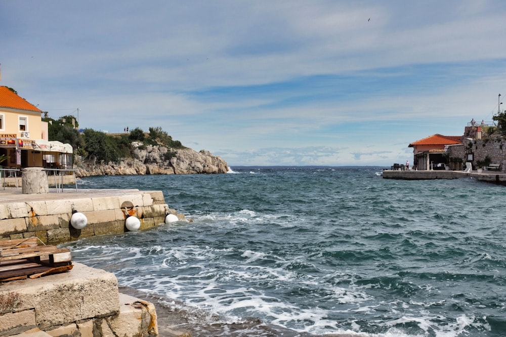 brown rock formation near body of water during daytime