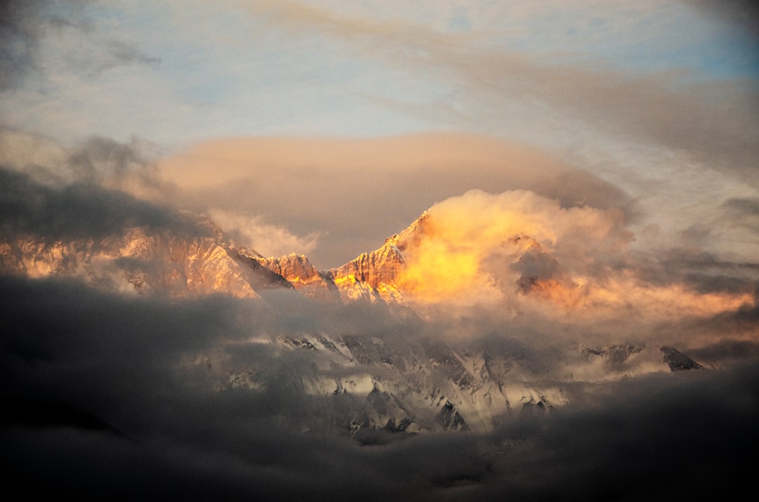 white clouds over mountains during daytime