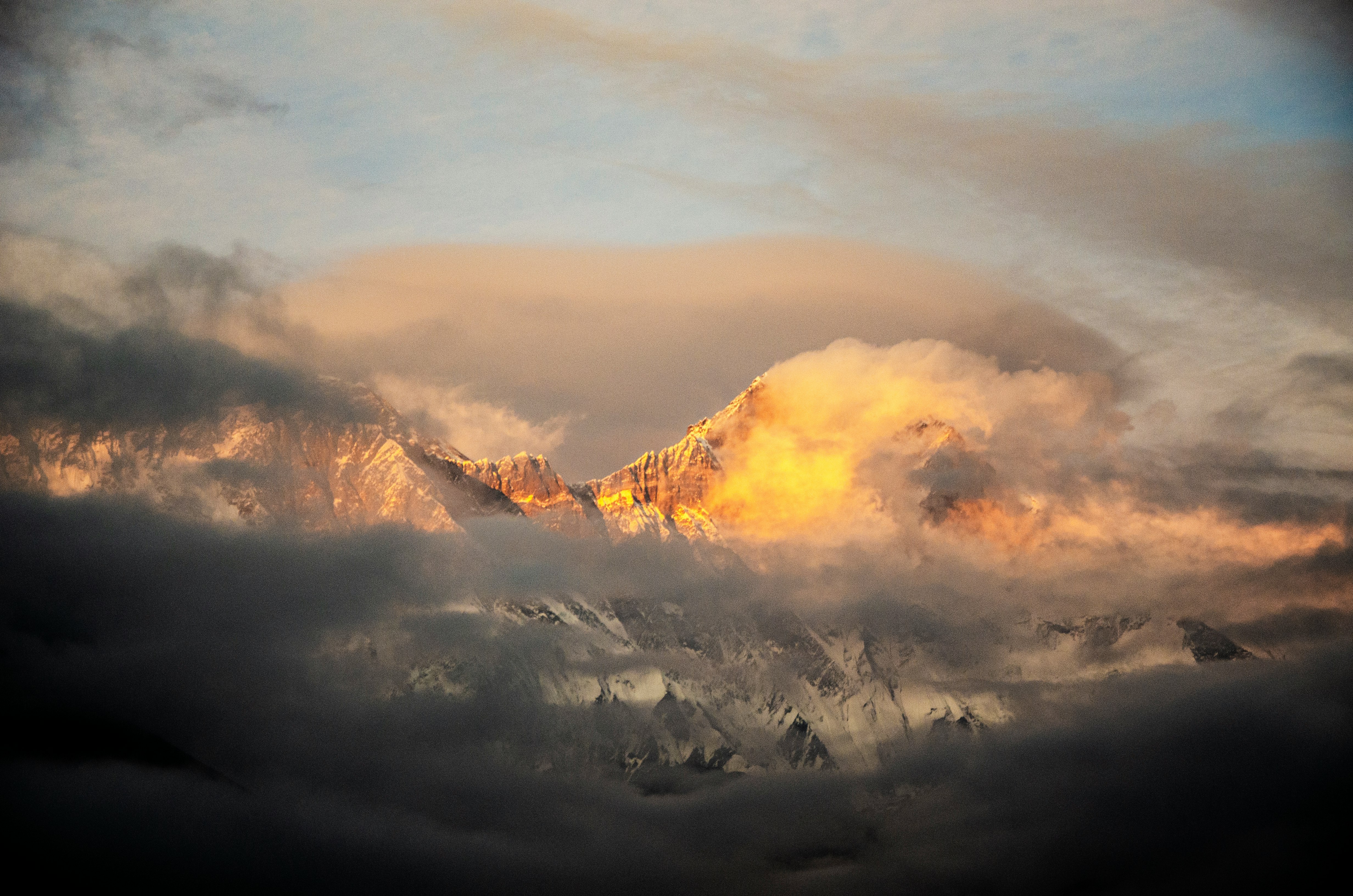 white clouds over mountains during daytime