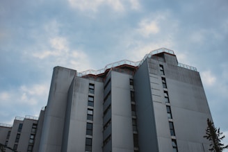 A sleek, minimalistic industrial warehouse exterior in Delhi NCR under clear skies.