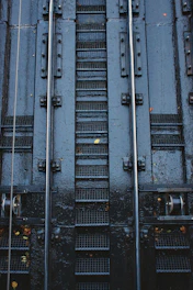 Close-up of galvanized steps attached to a container, highlighting sturdy craftsmanship and safety features.
