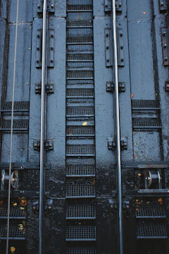 Close-up of galvanized steps attached to a container, highlighting sturdy craftsmanship and safety features.