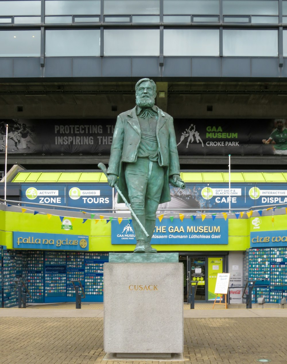 man in green coat statue