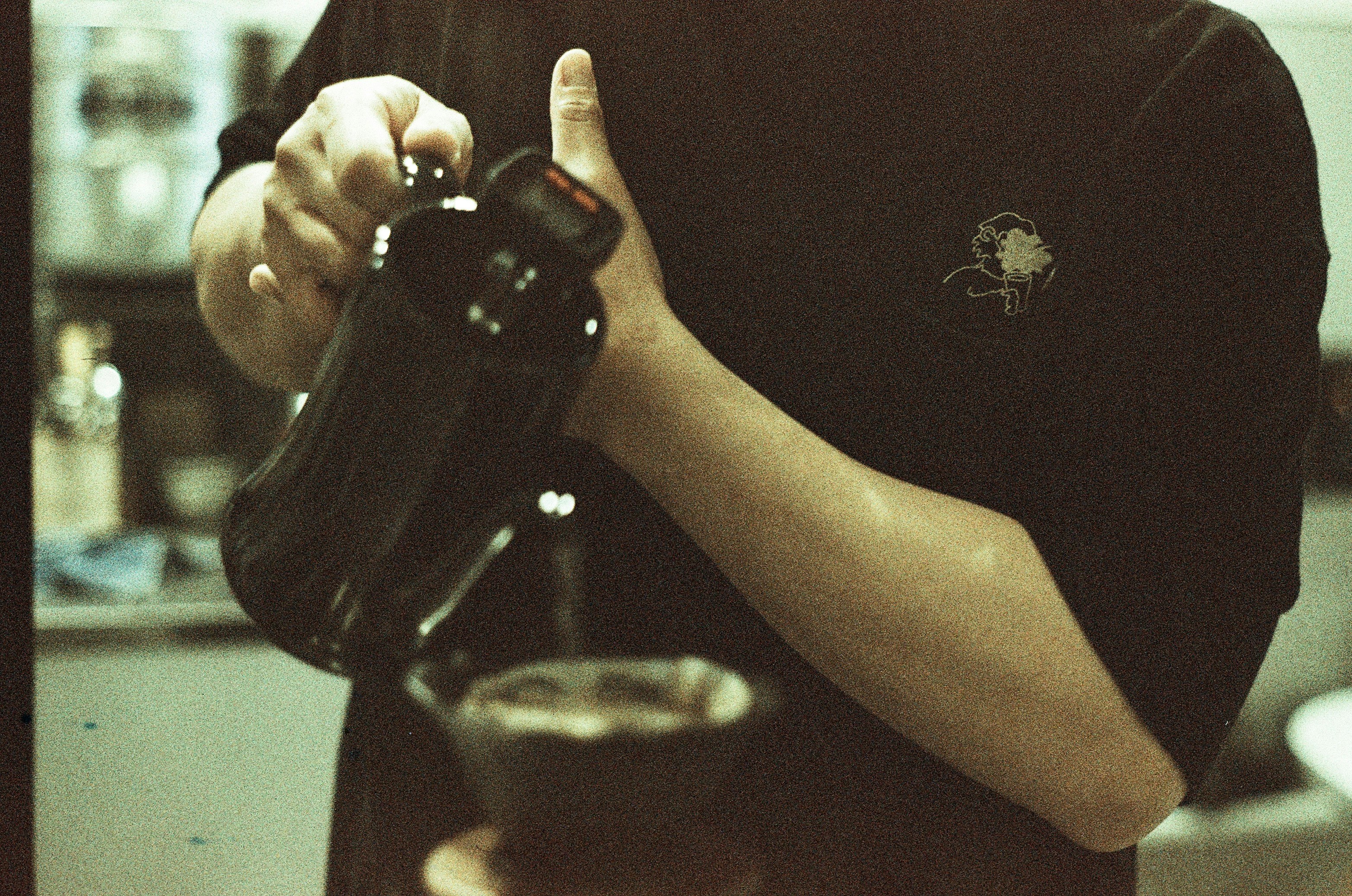 person holding black plastic bottle