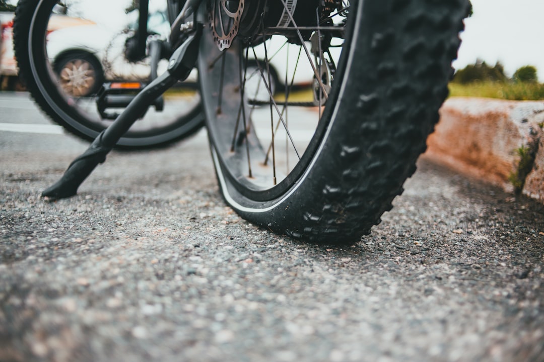 black bicycle wheel on gray concrete floor