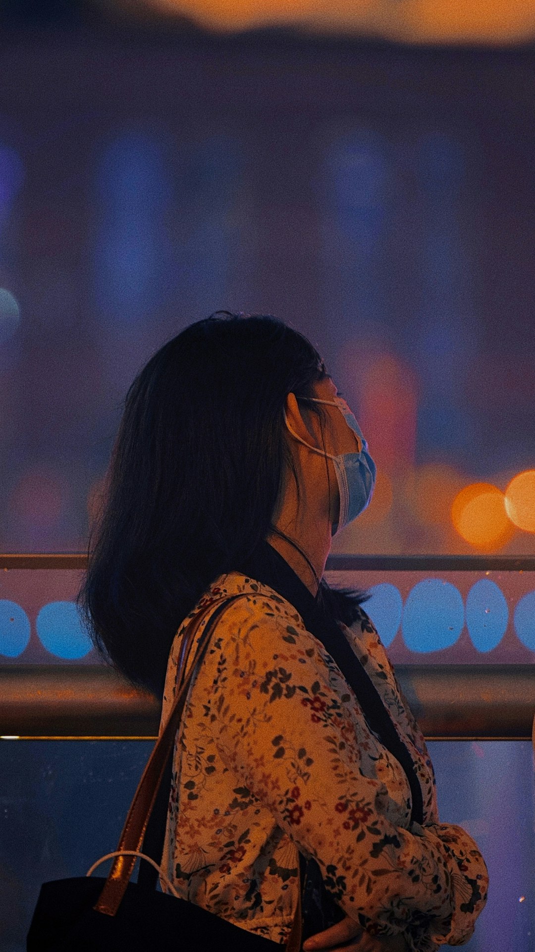 woman in blue and white floral shirt wearing eyeglasses