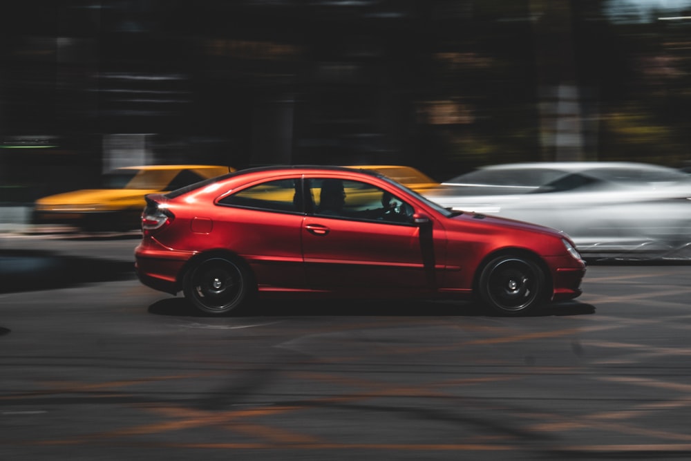 red sedan on road during night time