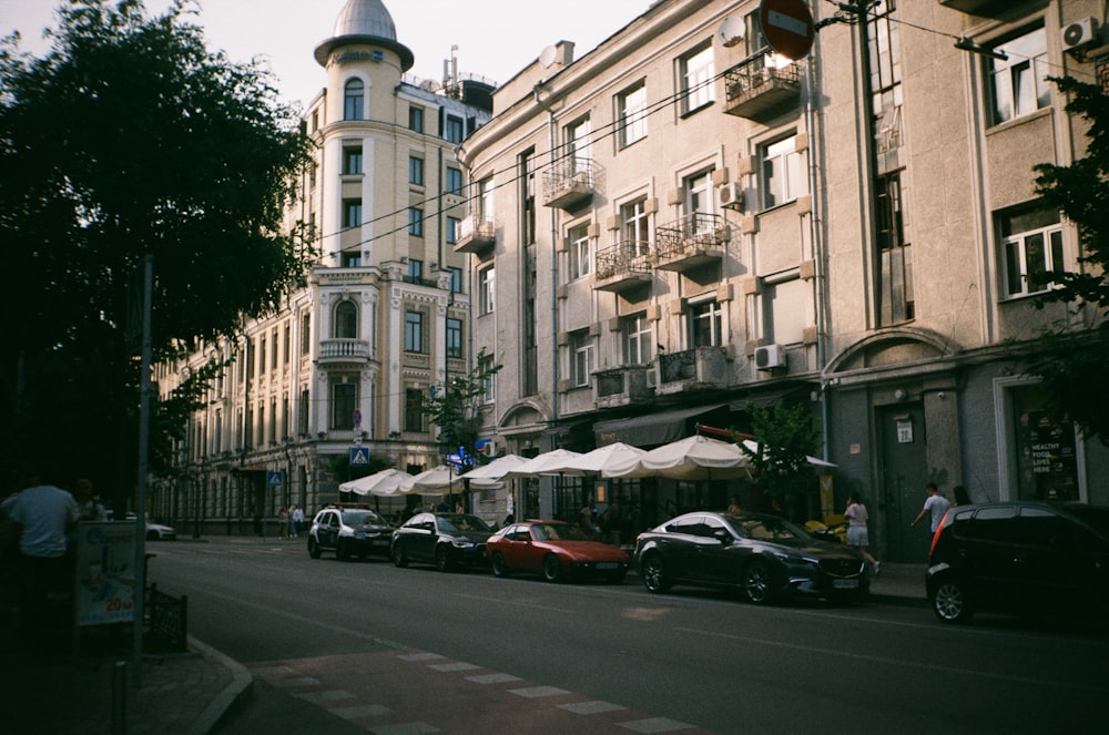 cars parked in front of white concrete building during daytime