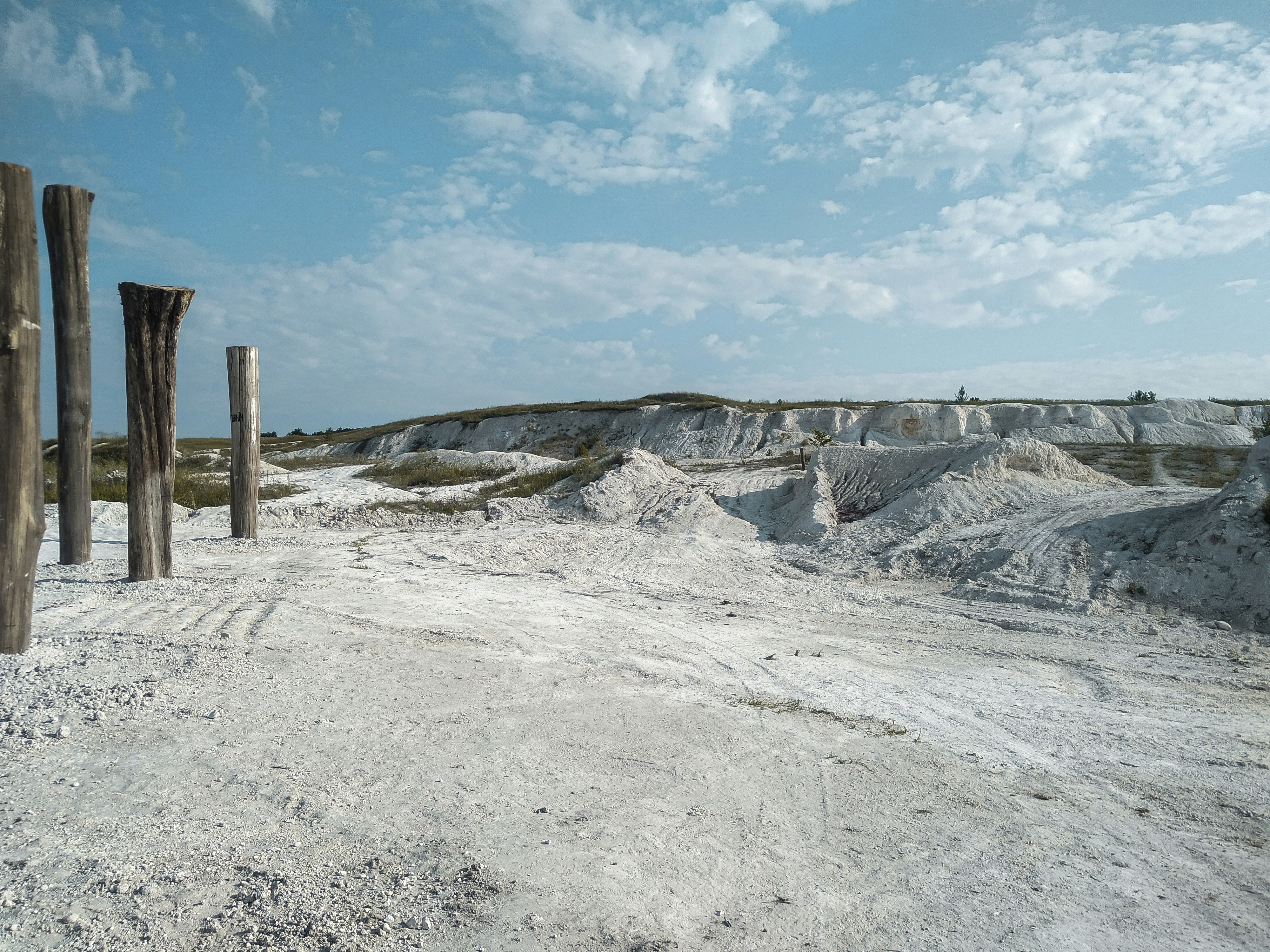 brown wooden post on gray rocky mountain under blue sky during daytime