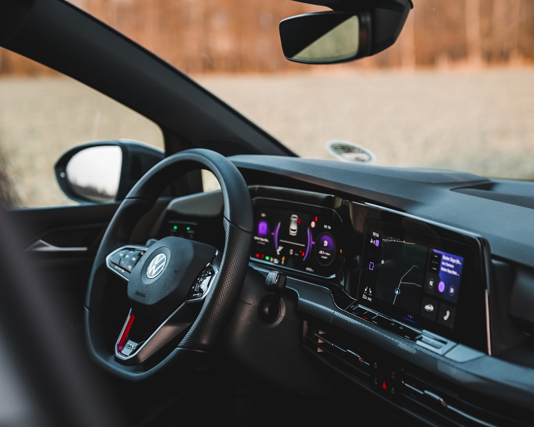 black car steering wheel during daytime