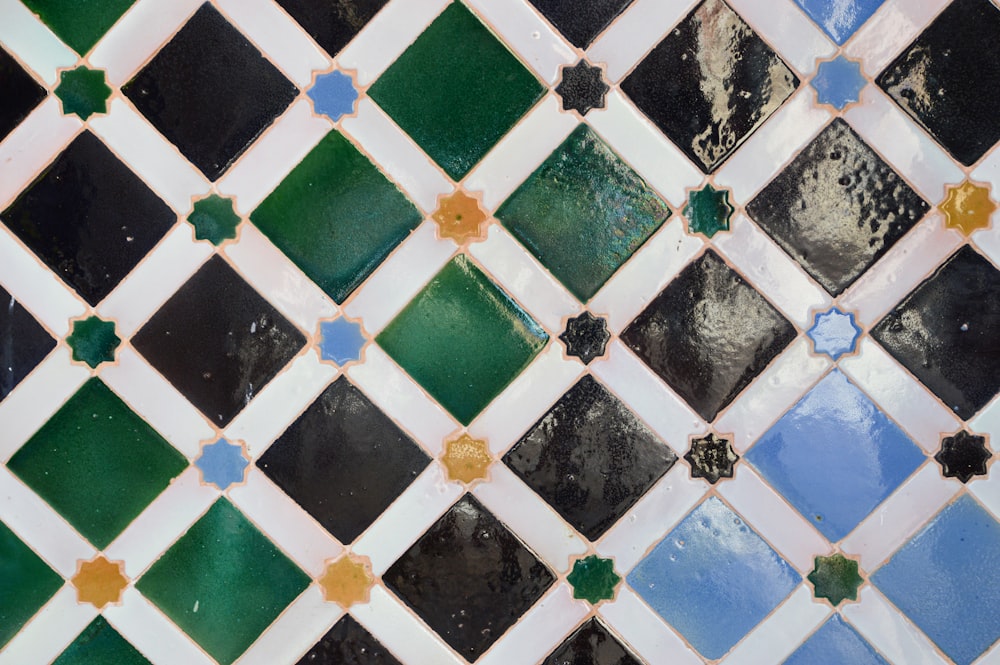 a close up of a tiled wall with different colors