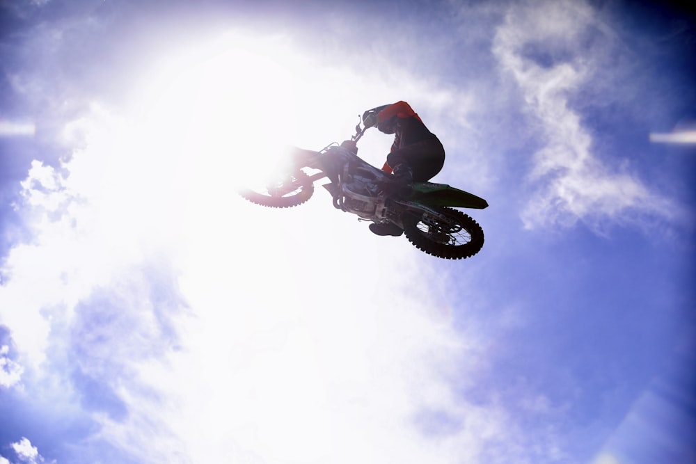 man in black jacket and black pants riding black motorcycle under blue sky during daytime