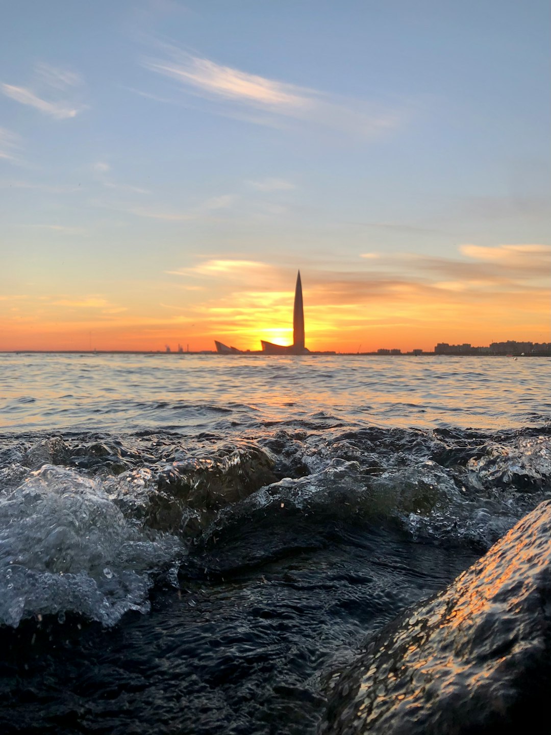 ocean waves crashing on rocks during sunset