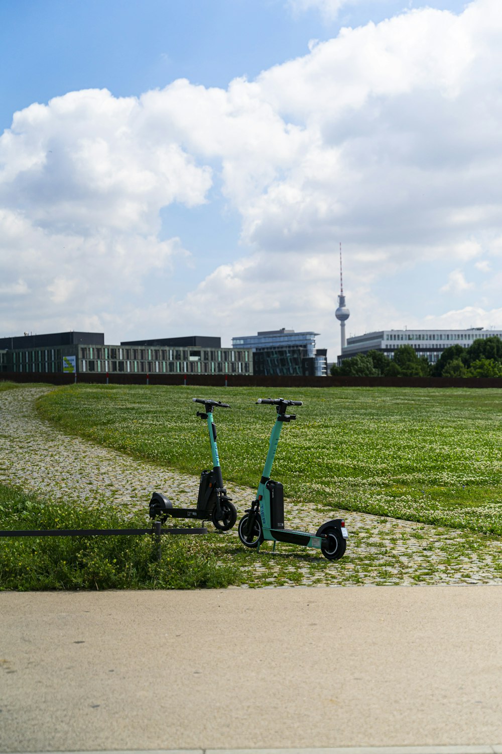 blue and black trike on green grass field during daytime