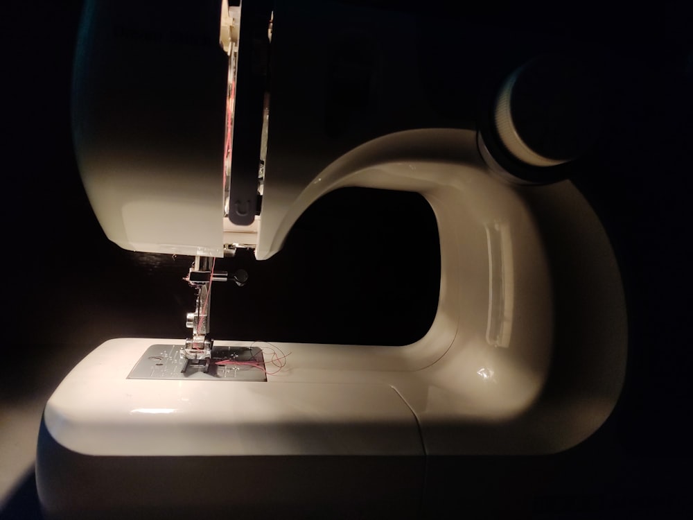 white sewing machine on table