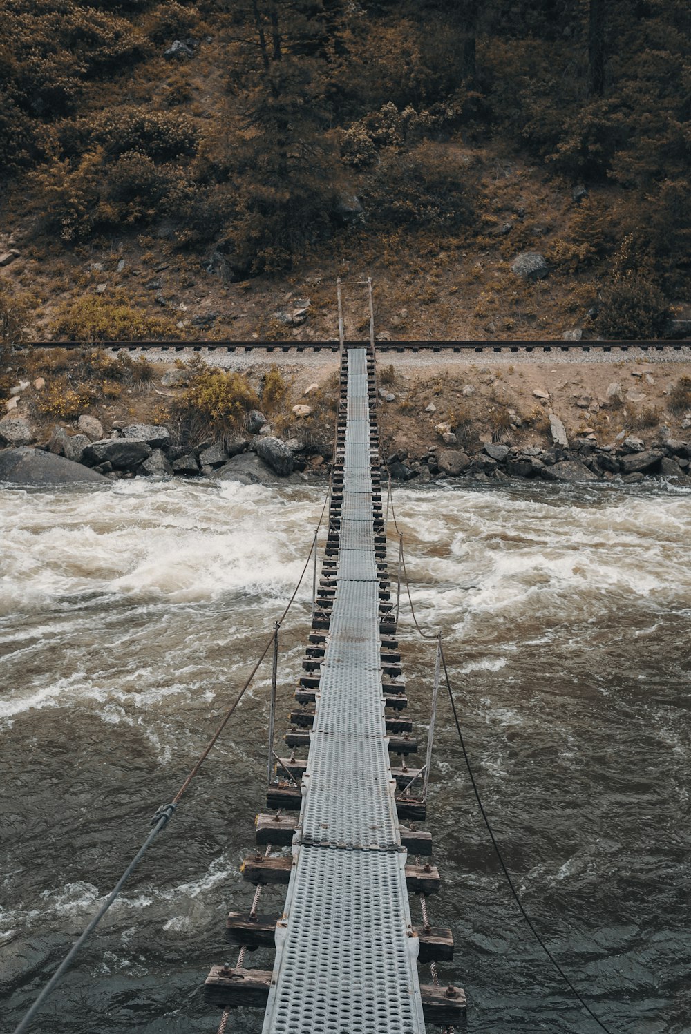 brown wooden bridge over river