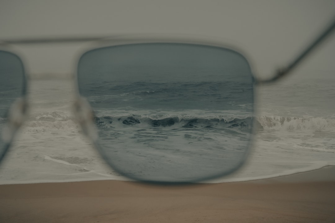 black framed sunglasses on white table