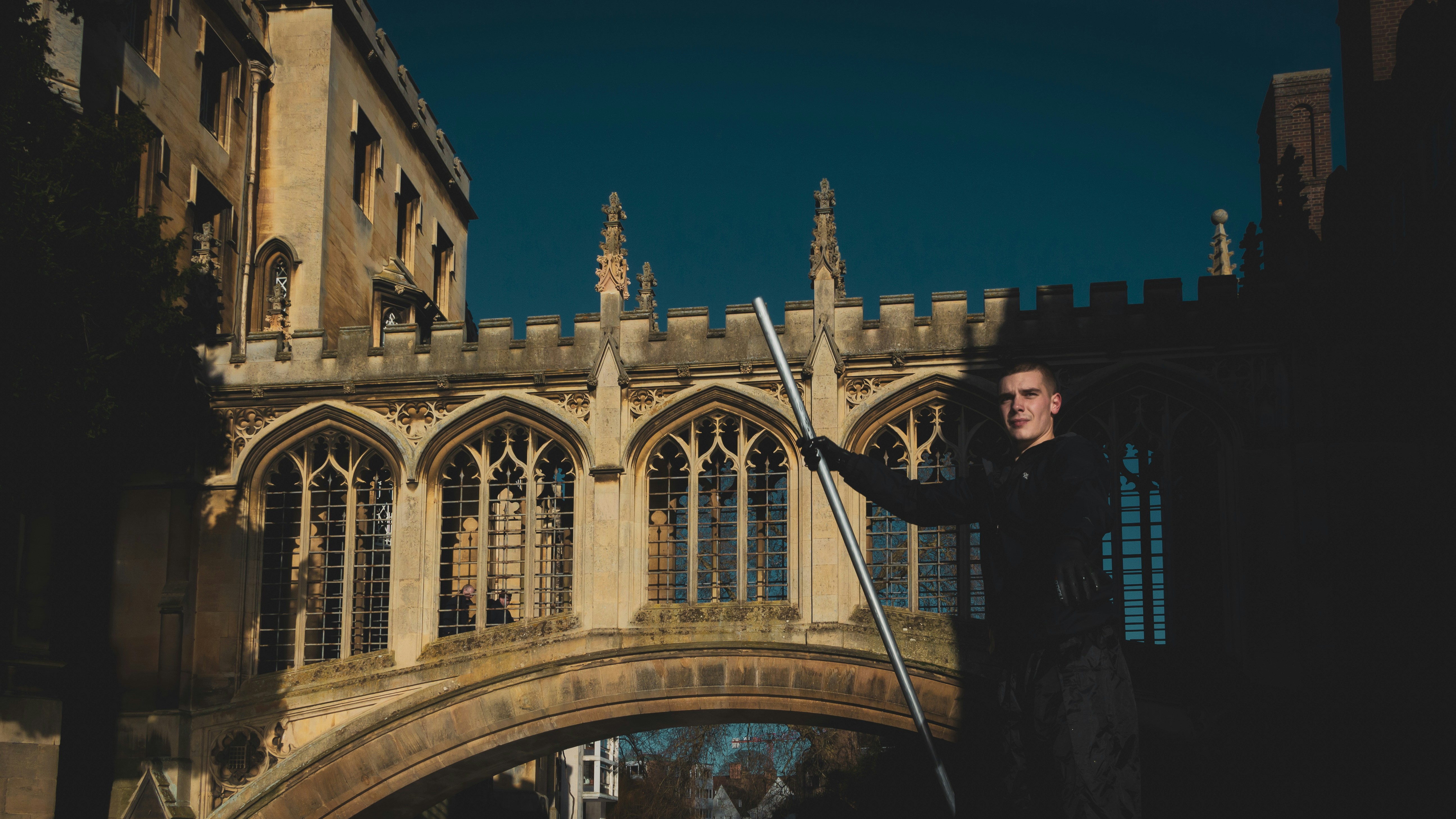 woman in black jacket standing on bridge