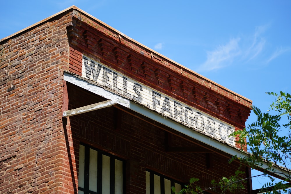 brown brick building with green plants