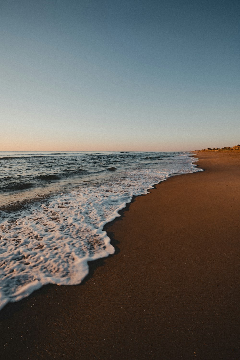 ocean waves crashing on shore during daytime