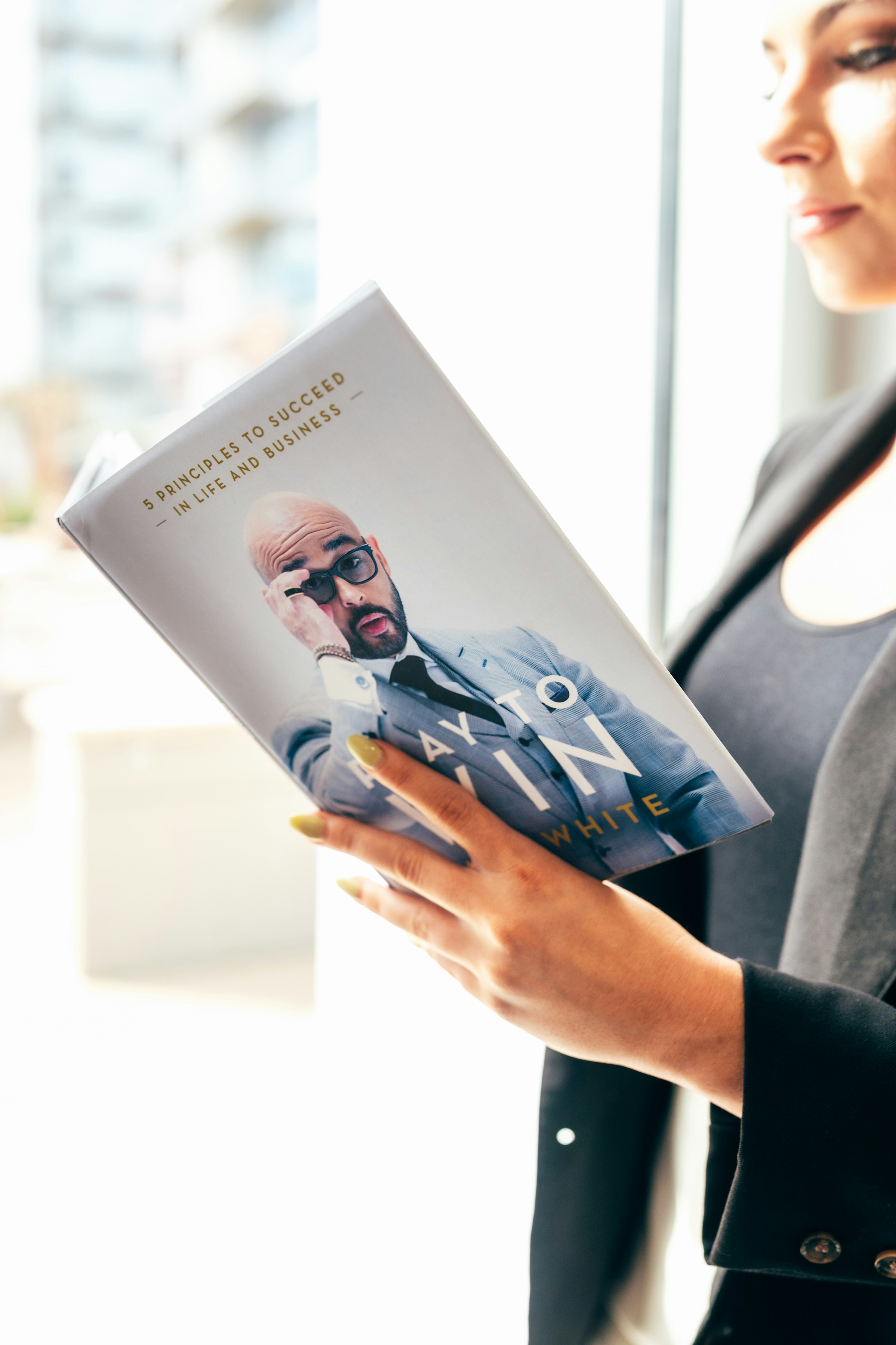 person holding white and blue book