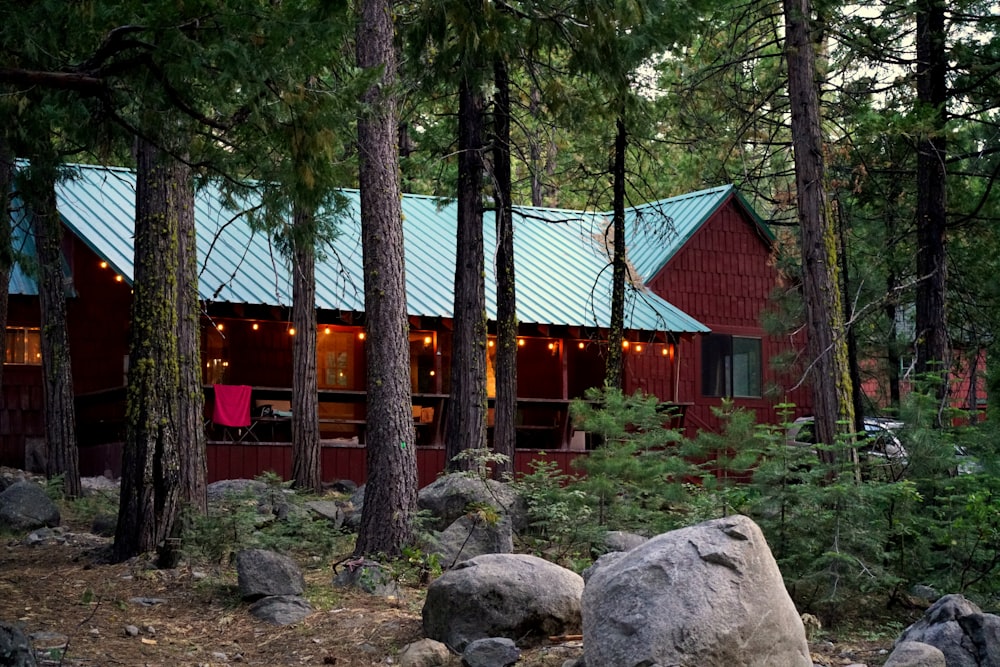 red and brown wooden house near trees during daytime