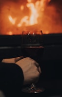 A cozy wine tasting event with friends clinking glasses in a warmly lit room