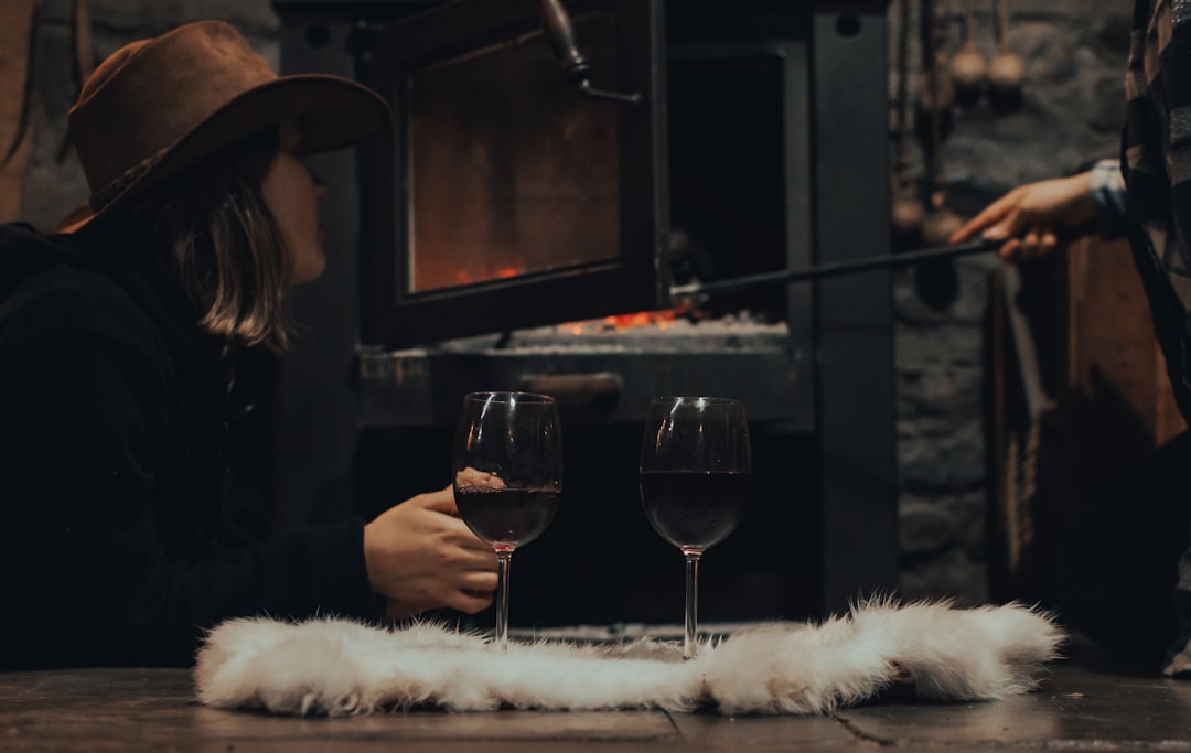 woman in black long sleeve shirt holding wine glass