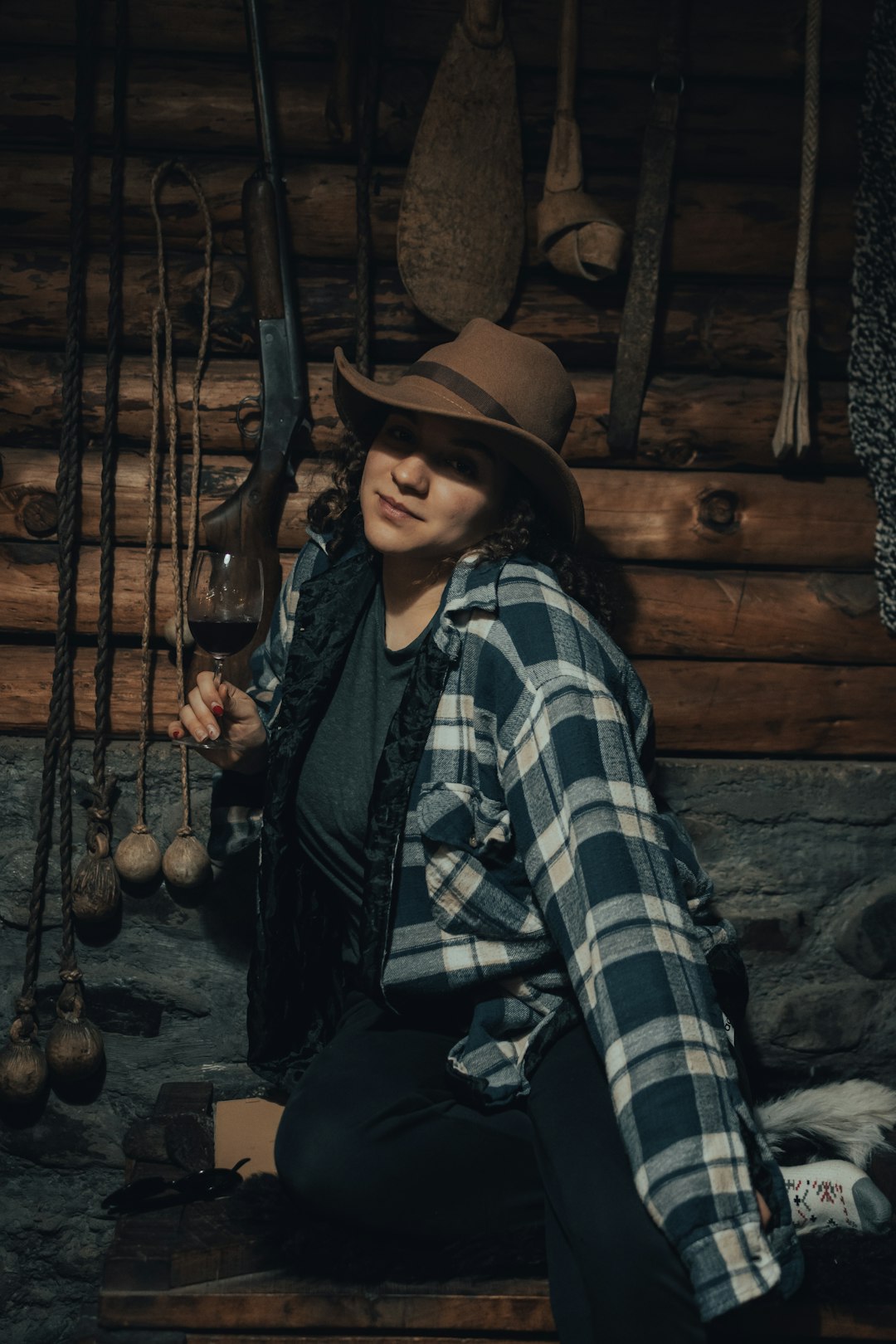 woman in black and white plaid dress shirt wearing brown cowboy hat