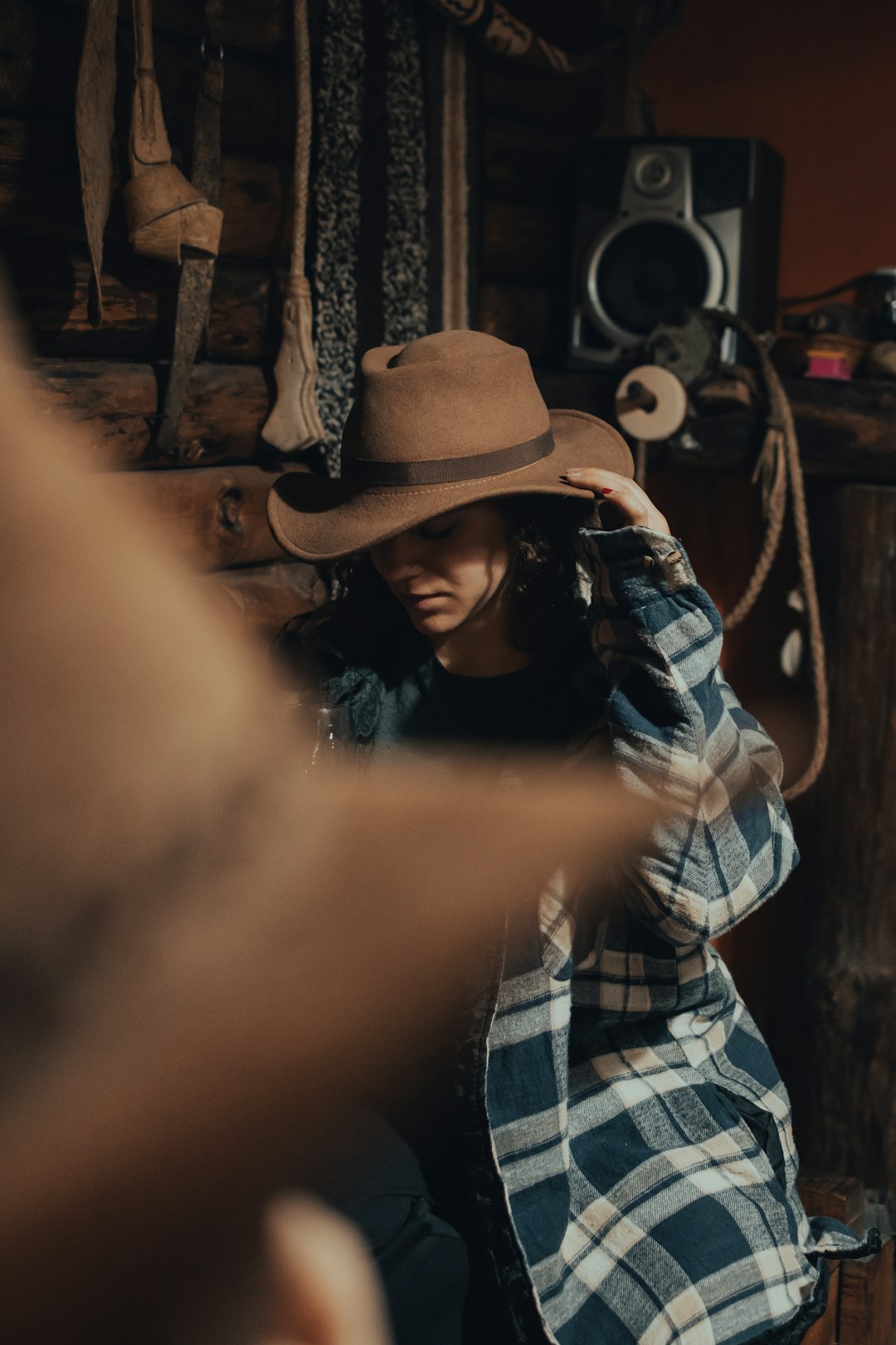 man in brown cowboy hat and blue and white plaid dress shirt