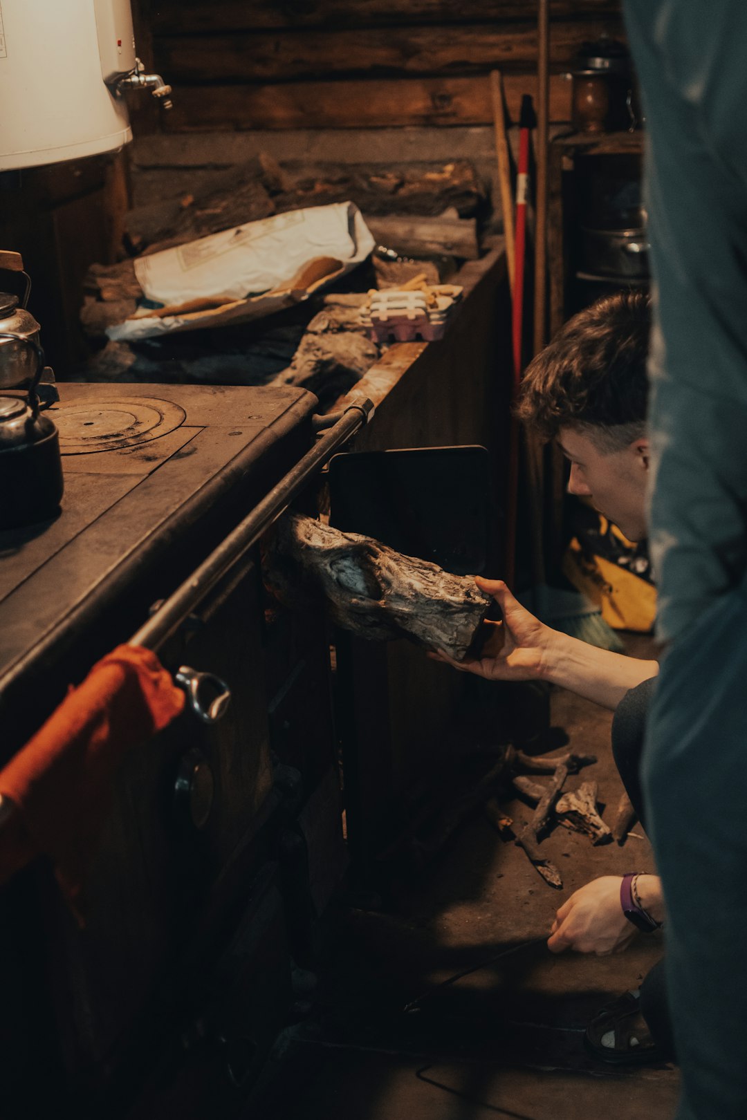 man in blue apron holding knife