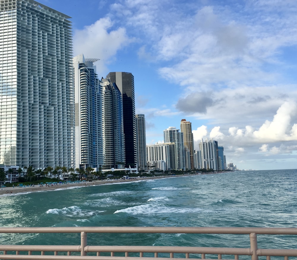 high rise buildings near sea under blue sky during daytime