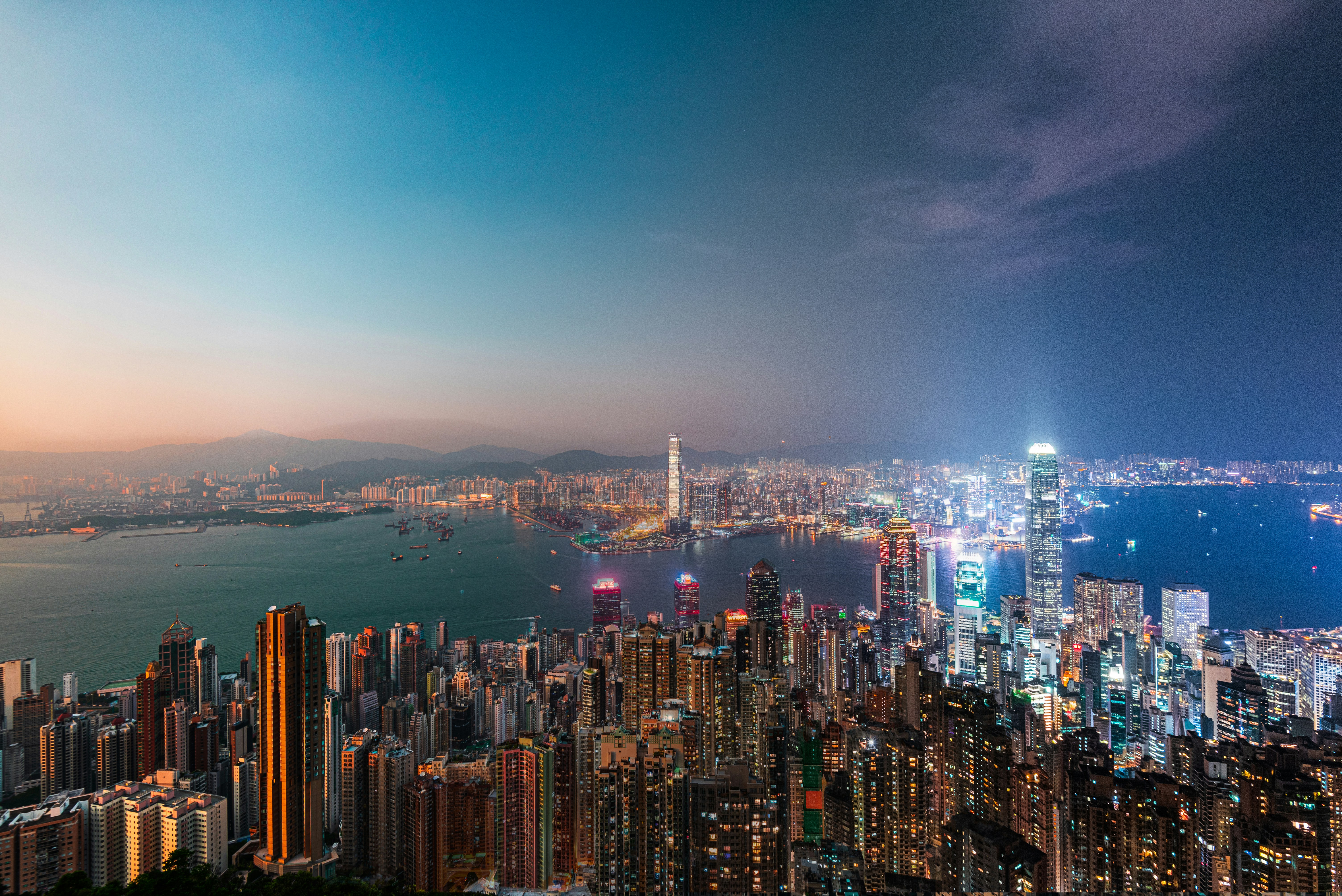 a view of a city at night from the top of a hill