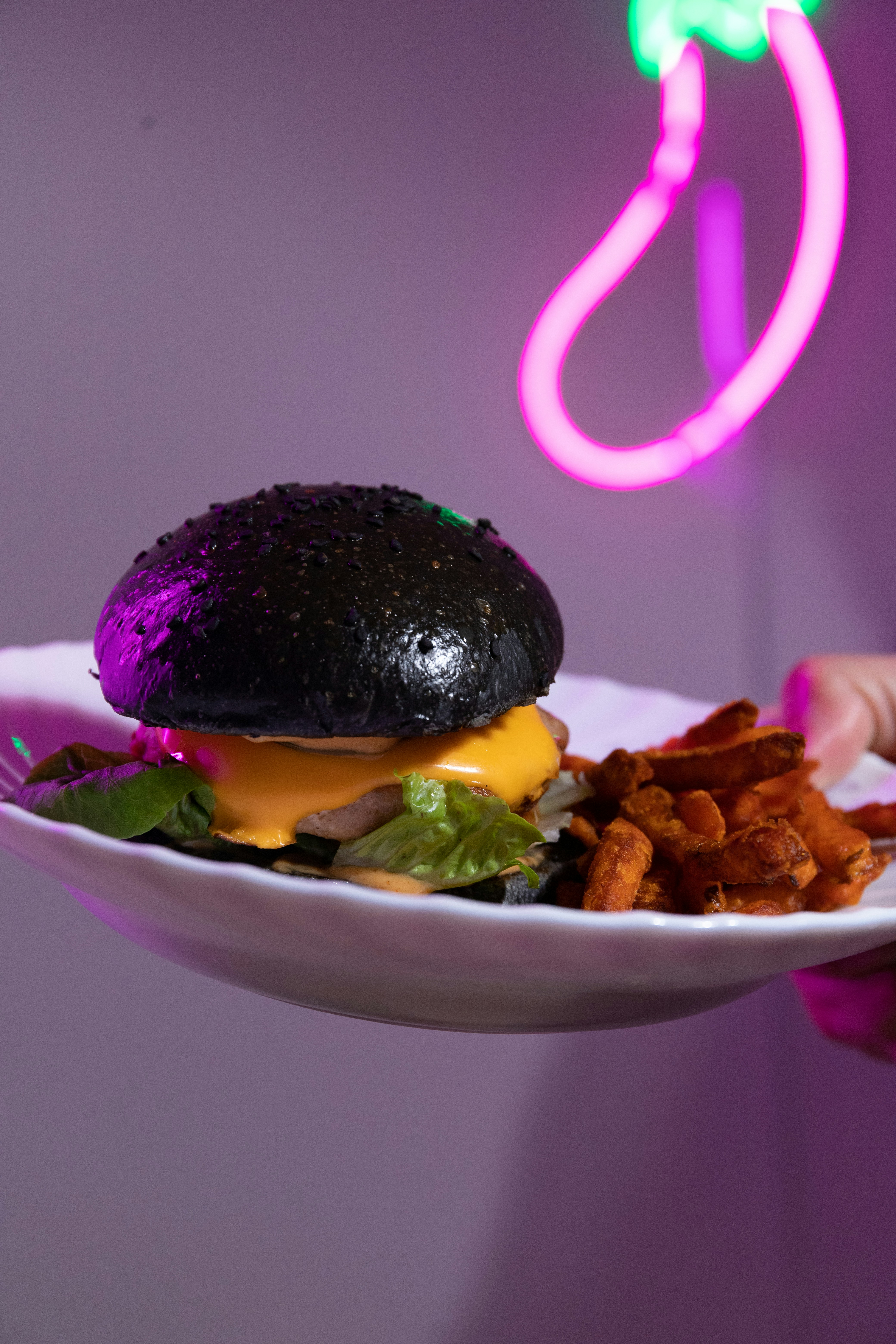 burger with lettuce and cheese on white ceramic plate