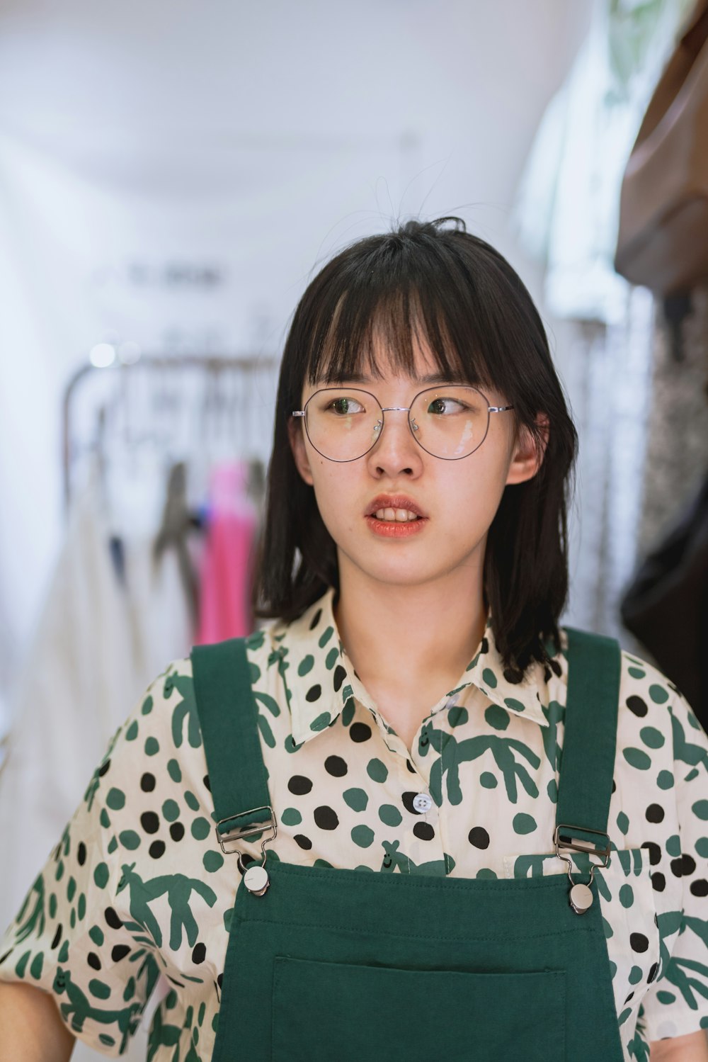 girl in green and white polka dot shirt smiling