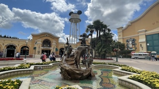 A warm photo of Pedro Ferrari welcoming guests at a Disney park entrance.
