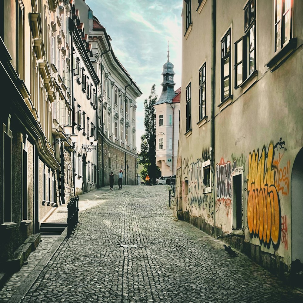 empty street between concrete buildings during daytime